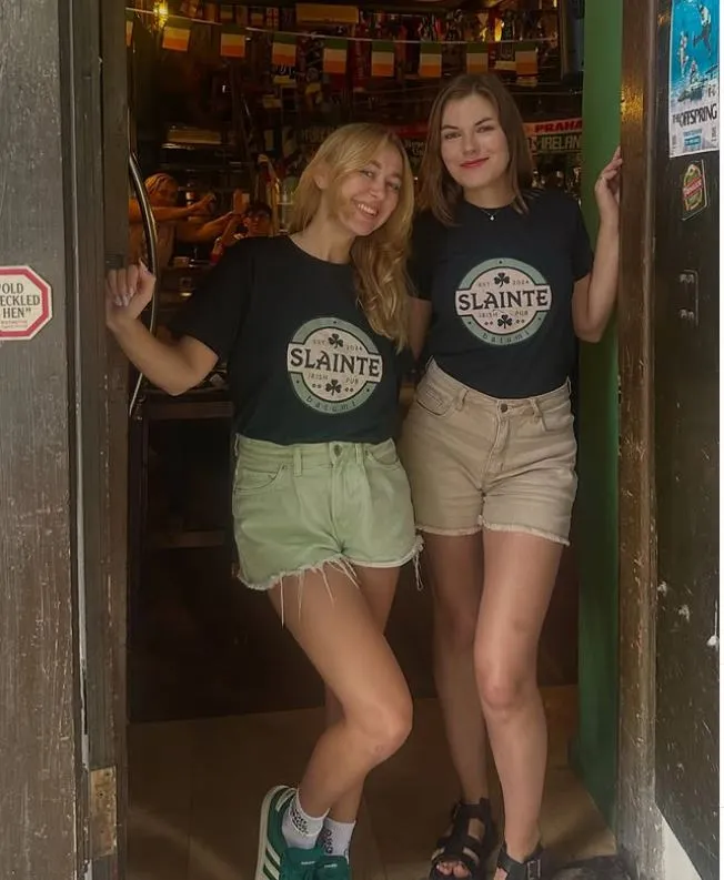 Friendly staff welcoming guests to Sláinte Irish Pub